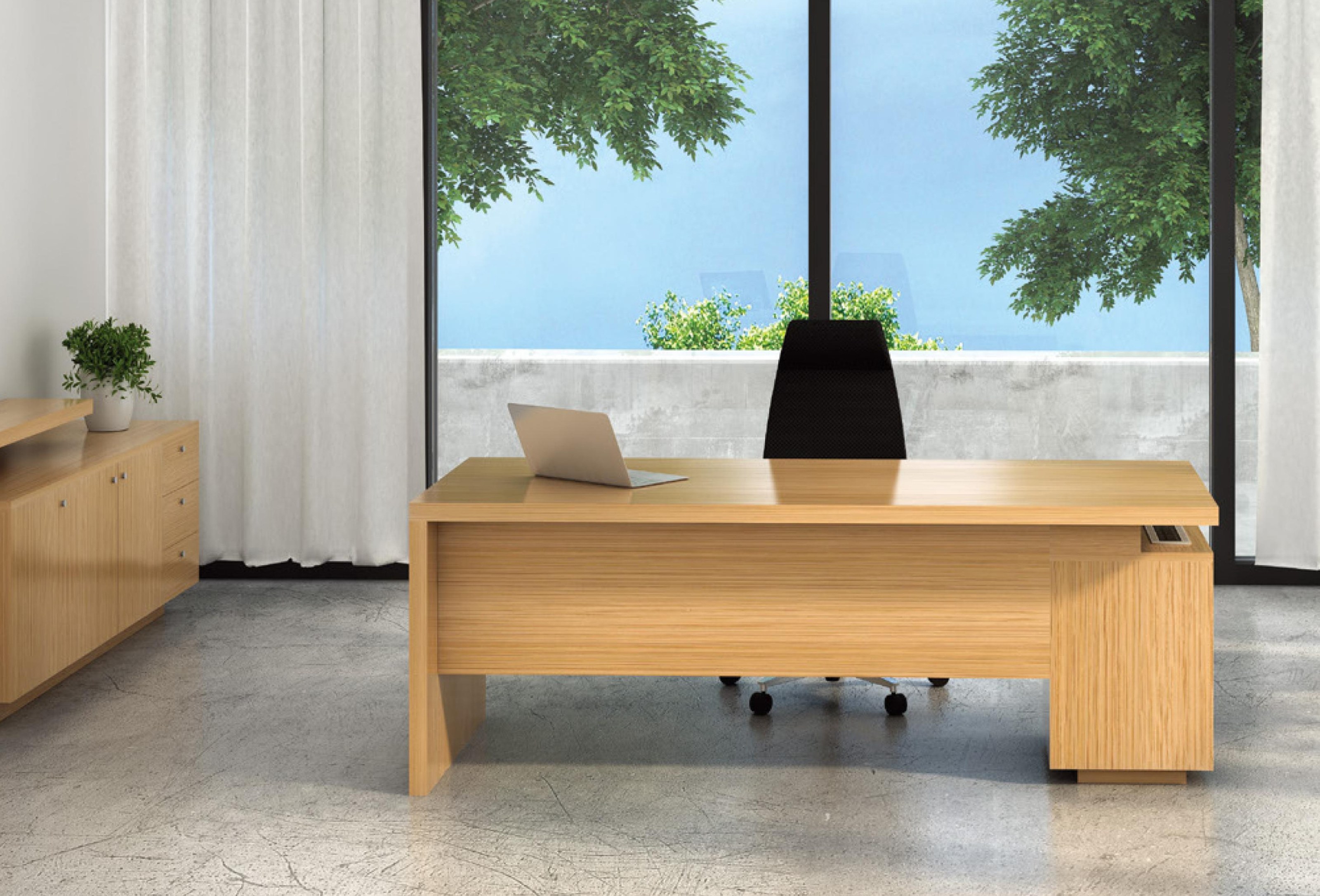 Hanson executive desk by a full-height window with a garden view